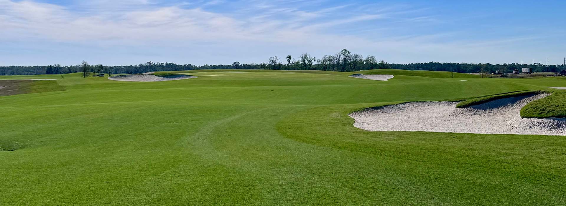 Image of golf ball on tee on grass.